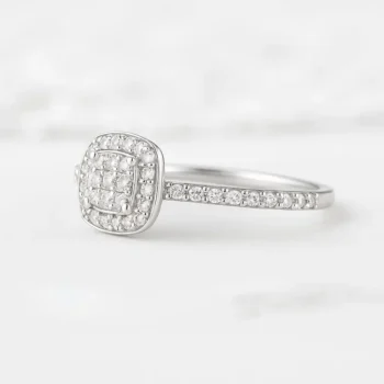 Close-up side view of cushion-shaped double halo diamond ring with round diamonds and white gold band