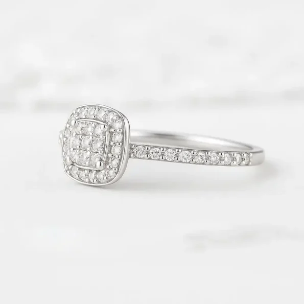 Close-up side view of cushion-shaped double halo diamond ring with round diamonds and white gold band