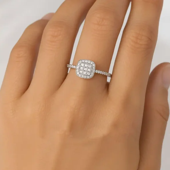 Square double halo diamond engagement ring on woman's hand with pave band in white gold