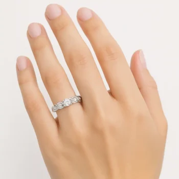 Elegant round diamond twist ring in white gold worn on finger